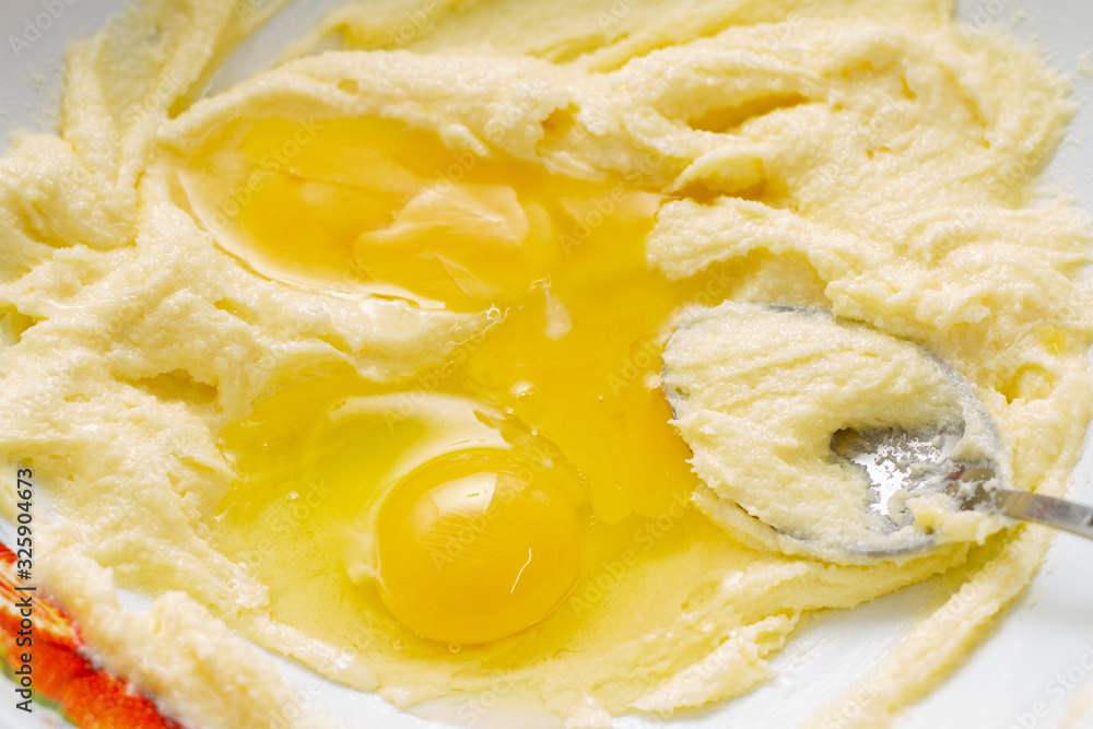 The process of making dough for baking. Bowl with flour, yolk and sugar The process of making dough for baking. Bowl with flour, yolk and sugar