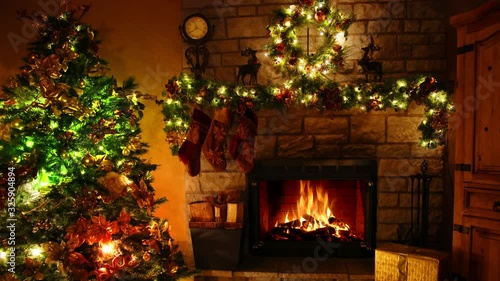 Marvellous 4k shot of firewood flame burning fireplace loop in cosy festive Christmas tree New Year decoration Noel room
