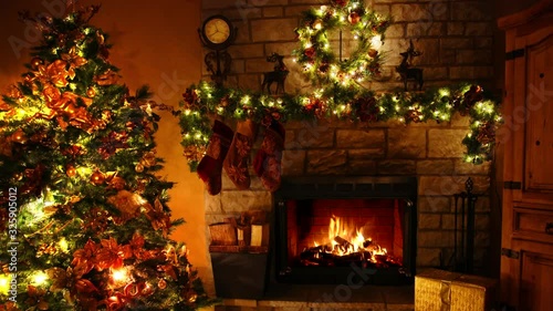 Impressive 4k shot of firewood flame burning fireplace loop in cosy festive Christmas tree New Year decoration Noel room