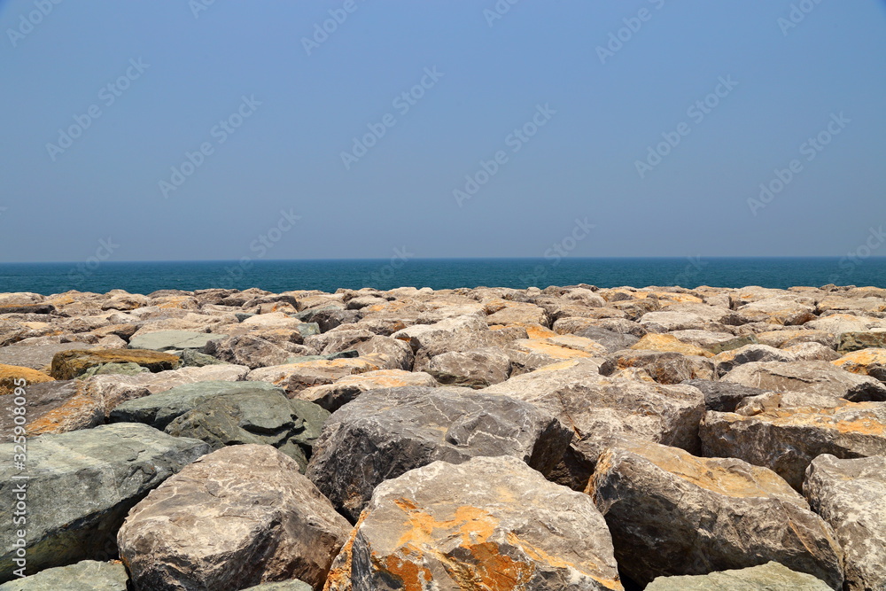 Sea coast coastline, rock breakwater at Dubai, United Arab Emirates
