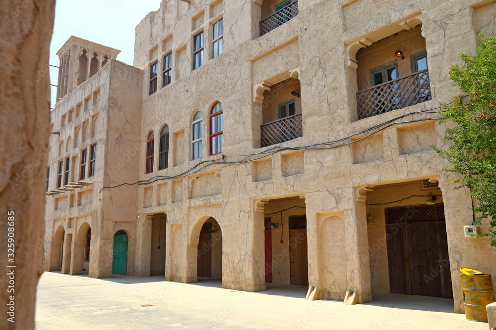 Old Dubai of buildings and traditional Arabian streets. Historical Al Fahidi neighborhood, Al Bastakiya in in Dubai.
