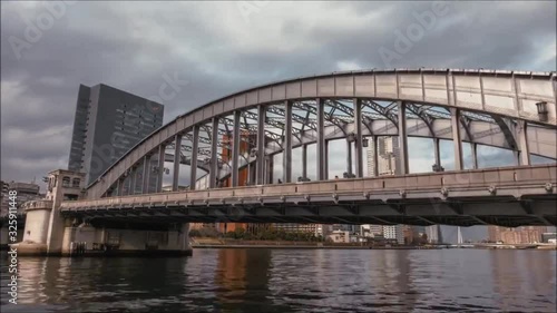 Huge modern urban steel bridge across big Tokyo city Japan downtown financial dictrict architecture day time lapse shot photo