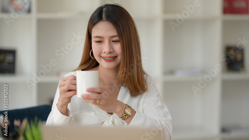 Close up view of happy businesswomen take a break and holding coffee cup