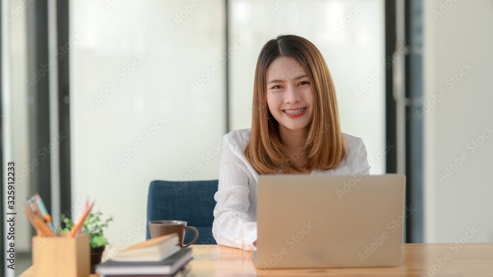 Cropped shot of female entrepreneur working while sitting at her working place Cropped shot of female entrepreneur working while sitting at her working place