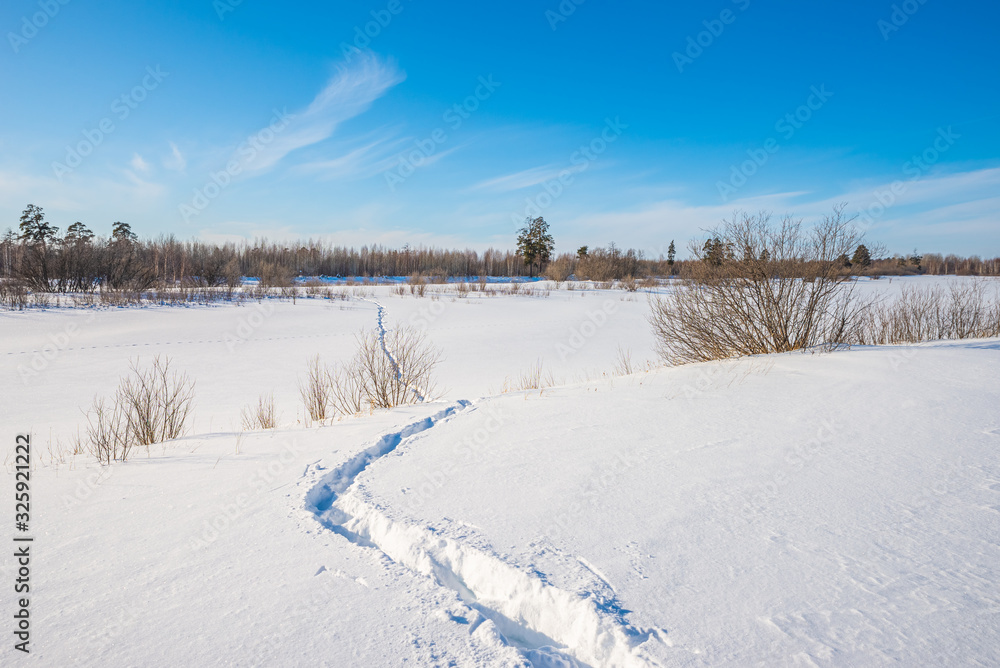 Footprints in deep snow. Winter landscape