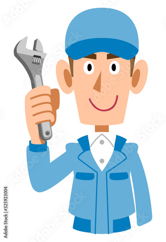 レンチを持つ青い作業着の男性