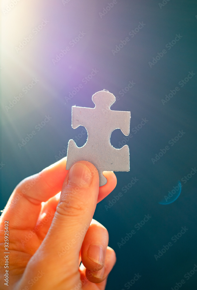 hand holding puzzle pieces finding solutions concept hand holding puzzle pieces finding solutions concept