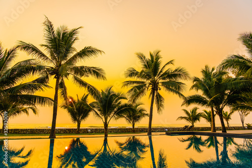 Beautiful nature with palm tree around outdoor swimming pool in hotel resort nearly sea ocean beach © siraphol