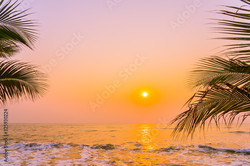 Beautiful nature with palm tree around sea ocean beach at sunset or sunrise