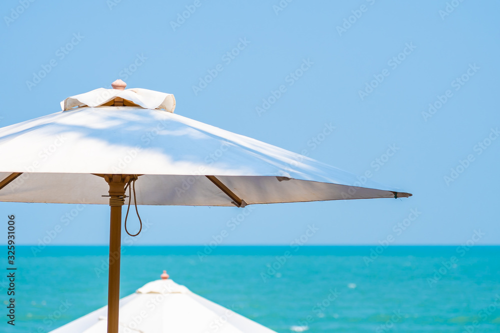 White umbrella around beautiful tropican nature of beach sea ocean