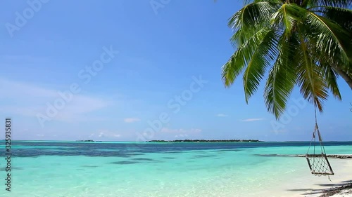 Magnificent steady paradise shot of tropical palm tree in windy white sand luxury beach in turquoise blue ocean seascape