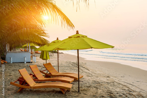 Beach chair under the big umbrella and was on the beach. Beautiful beach. Chairs on the sandy beach near the sea. Summer holiday and vacation concept for tourism. Inspirational tropical landscape.