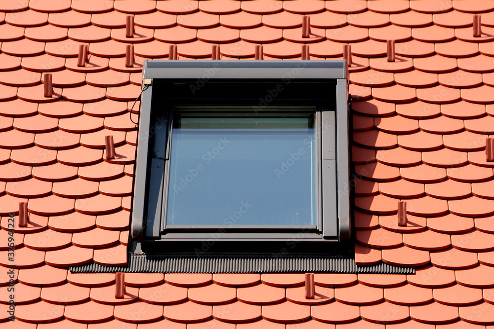 Modern new rectangle roof window with strong metal frame mounted on top ...