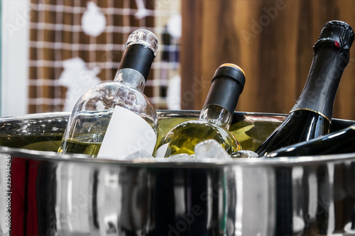 different bottles of wine and champagne in an ice bucket at a tasting or restaurant