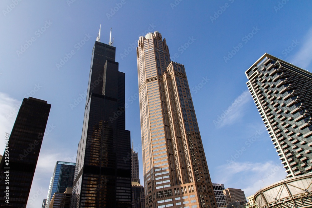 Modern skyscrapers in a financial district at sunset, bottom view, real estate and success concept, USA