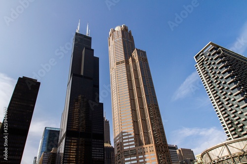Modern skyscrapers in a financial district at sunset, bottom view, real estate and success concept, USA