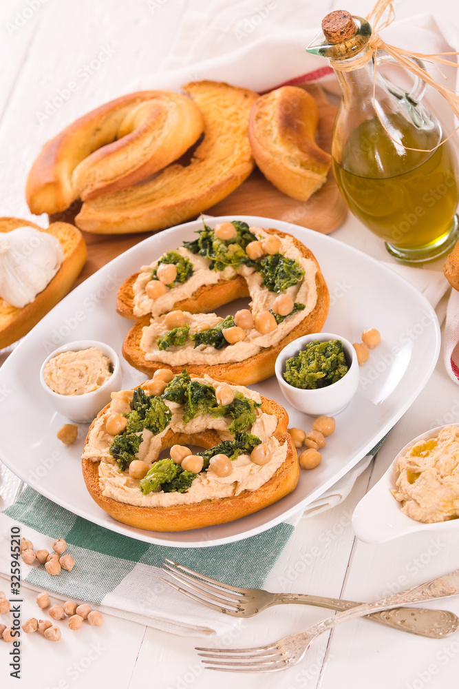 Friselle with turnip tops and hummus. Friselle with turnip tops and hummus.