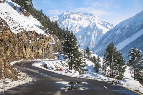 A curvy road passing through snow covered mountains of Himalayas at Drass. Srinagar-Leh Highway. BEACON. BRO. NHAI photo