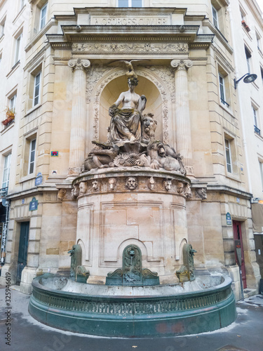 Cuvier Fountain, Paris, Linné street, 5th arrondissement, France. Created by the architect Alphonse Vigoureux in 1840. Vertical shot. Natural history allegory and historic monument. photo