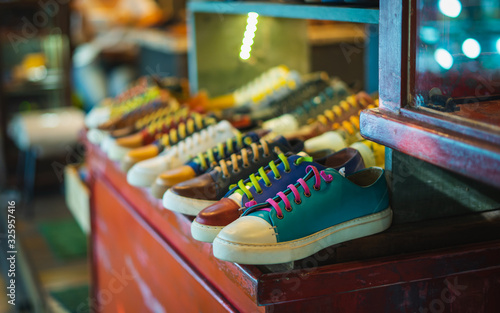 colorful vintage men shoes on wooden cabinet . selective focus