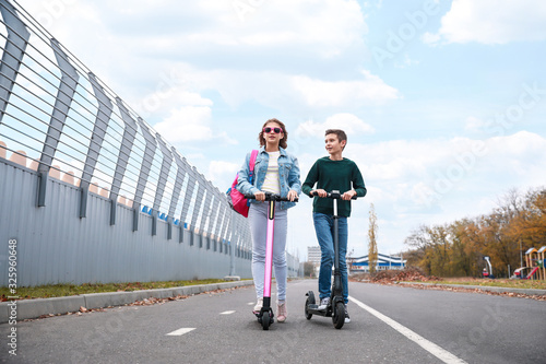 Active teenagers riding kic...