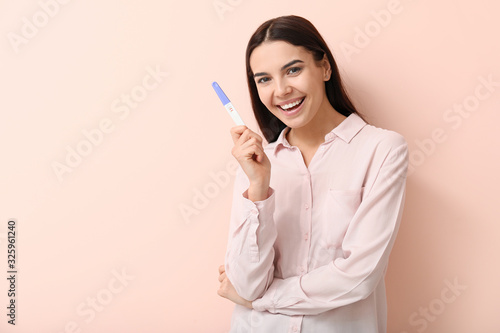 Happy young woman with preg...