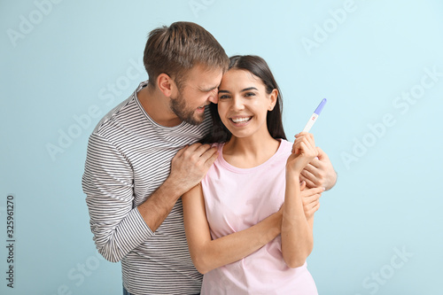 Happy young couple with pre...