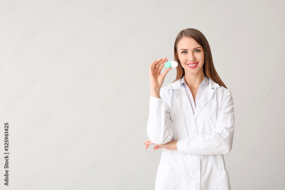 Ophthalmologist with contact lenses on light background Ophthalmologist with contact lenses on light background