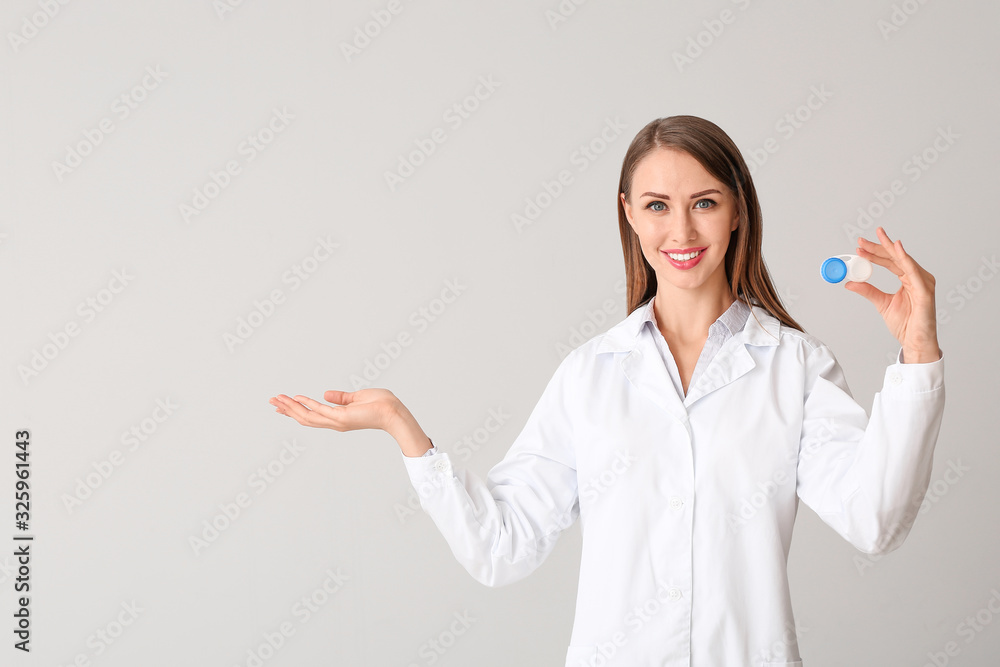 Ophthalmologist with contact lenses on light background Ophthalmologist with contact lenses on light background