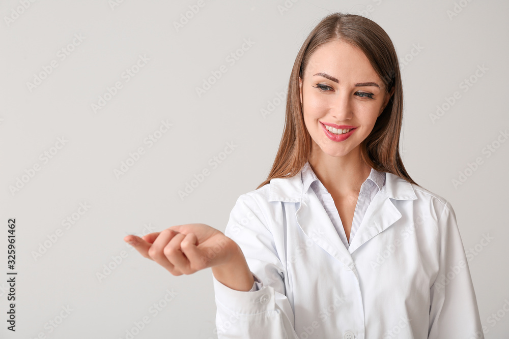 Ophthalmologist with contact lens on light background Ophthalmologist with contact lens on light background