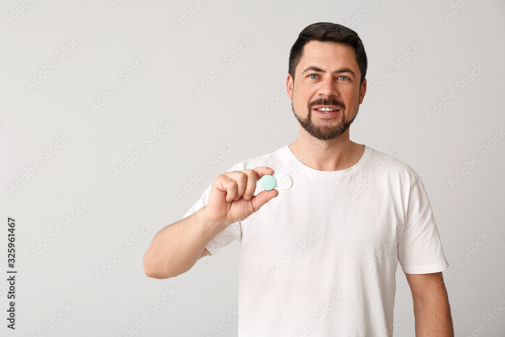 Man with contact lenses on light background Man with contact lenses on light background