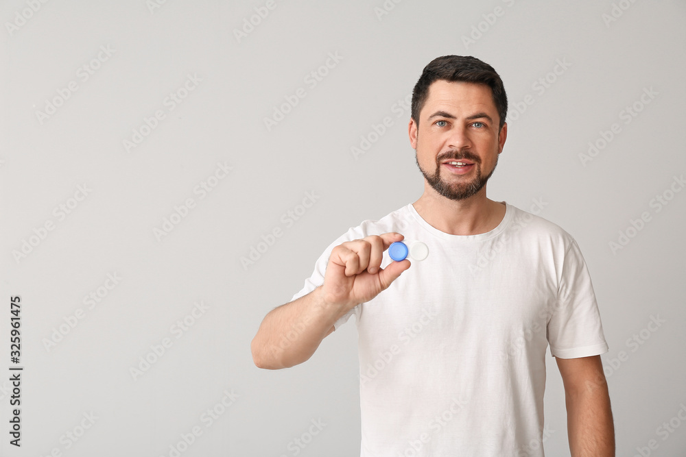 Man with contact lenses on light background Man with contact lenses on light background
