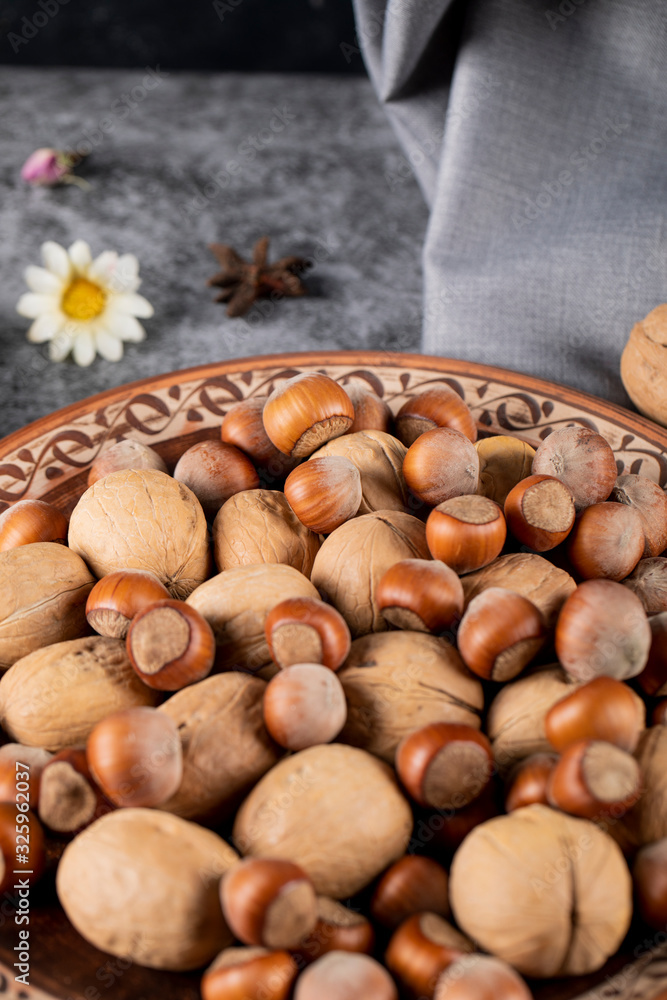 Nuts and walnuts in a pottery bowl Nuts and walnuts in a pottery bowl