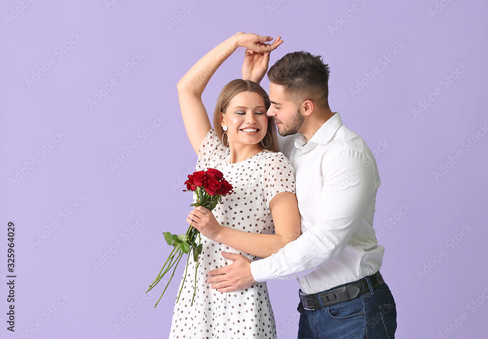 Happy young couple with bouquet of flowers on color background Happy young couple with bouquet of flowers on color background