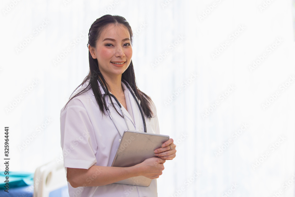 Portrait of woman doctor standing in Patient Room at hospital. looking at camera. Portrait of woman doctor standing in Patient Room at hospital. looking at camera.