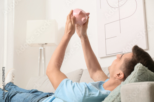 Happy man with piggy bank a...