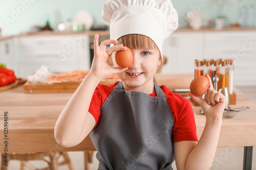 Little Girl Chef Holding Eg...