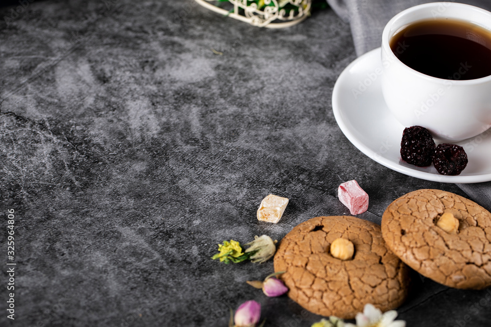 A cup of tea with almond cookies on the marble A cup of tea with almond cookies on the marble