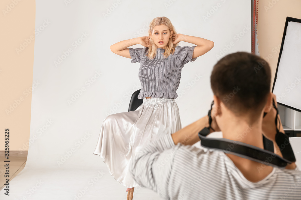 Fototapeta premium Professional photographer working with model in studio