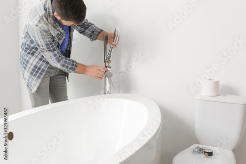 Plumber repairing water tap...