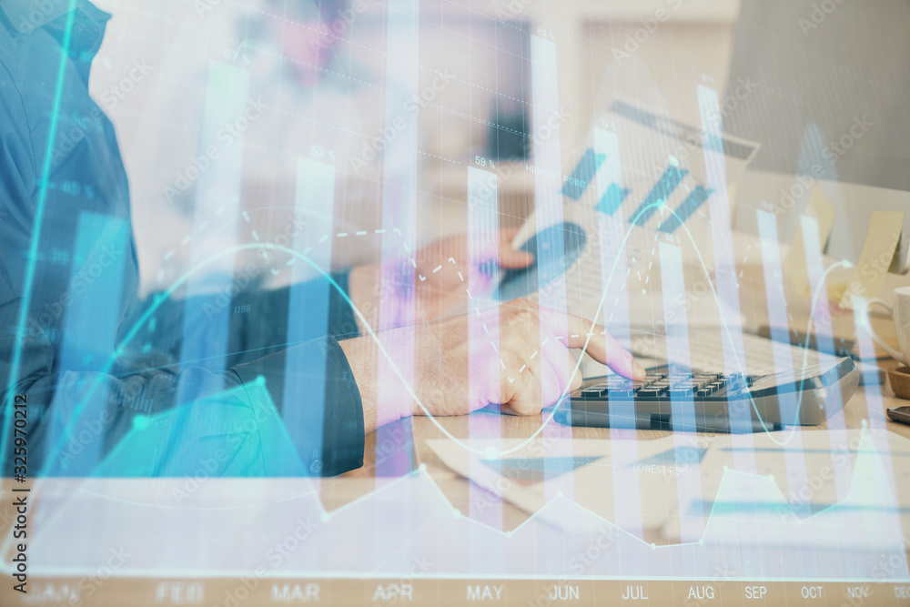 Double exposure of graph with man typing on computer in office on background. Concept of hard work. Closeup. Double exposure of graph with man typing on computer in office on background. Concept of hard work. Closeup.