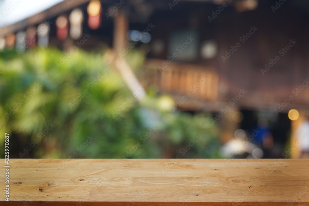 Empty dark wooden table in front of abstract blurred bokeh background of restaurant . can be used for display or montage your products.Mock up for space.