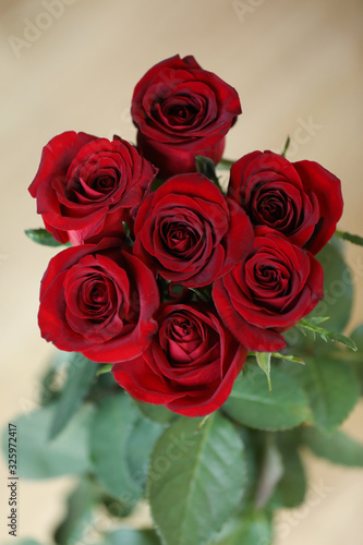 bouquet of red roses on a wooden background