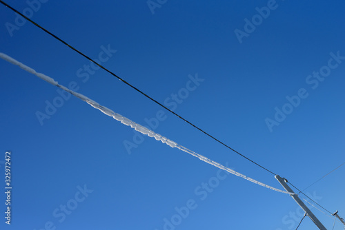 Wallpaper Mural ice-covered cables on the blue sky background Torontodigital.ca