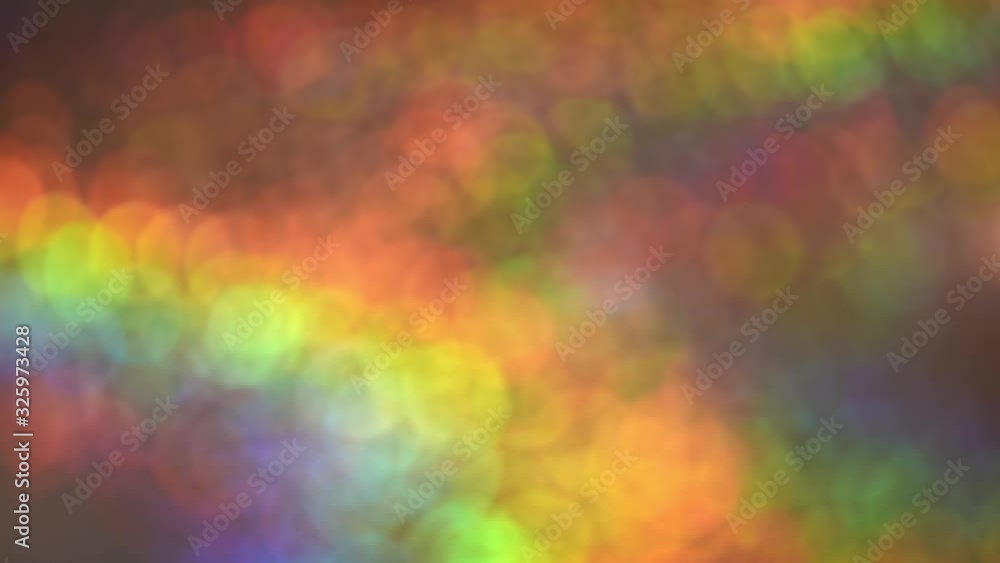 Bokeh rainbow defocused blurred lights moving, blinking  and changing, colorful festive party background.