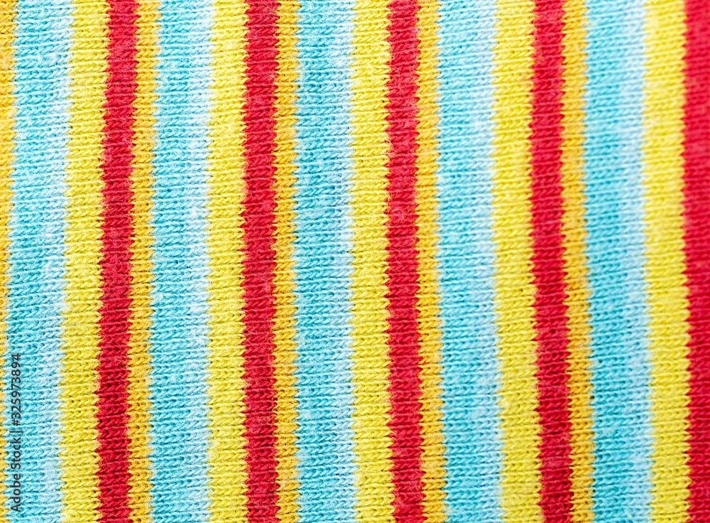 Abstract color knitted texture with multicolored pattern. Selective focus