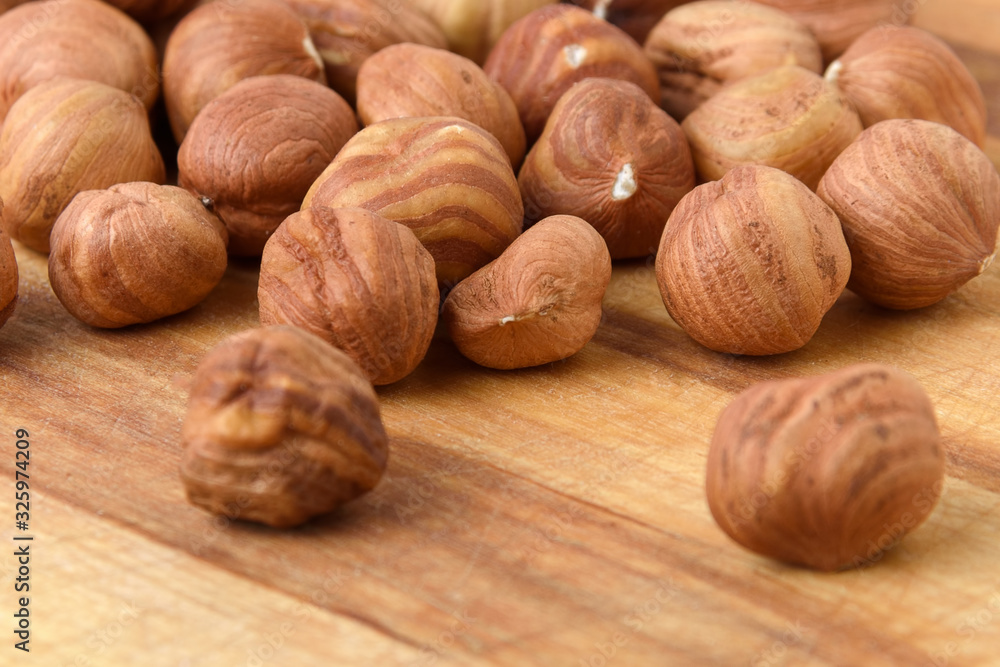 Ripe hazelnuts in bulk on a wooden table Ripe hazelnuts in bulk on a wooden table