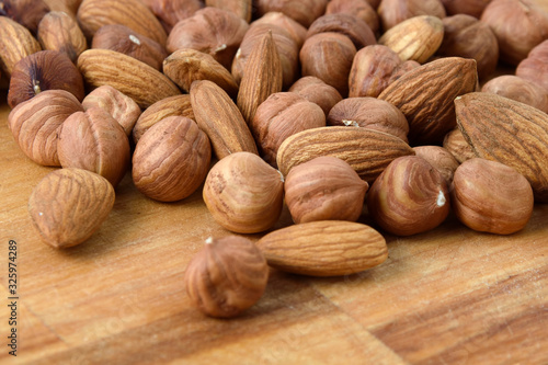 A mixture of ripe hazelnuts on a wooden table