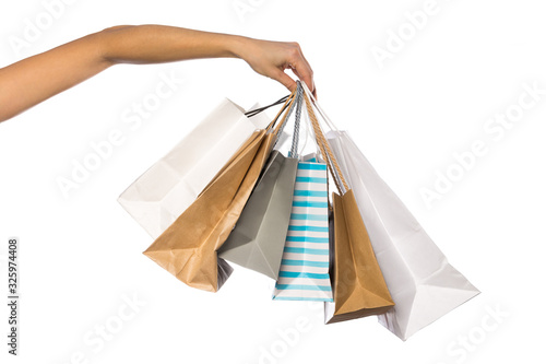Paper craft bag, eco packaging in a female hand, isolated on white background, with place for text.