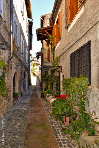 Fototapeta Naklejka Na Ścianę i Meble -  Anagni, Italy, A narrow street between the old stone houses of a medieval village.